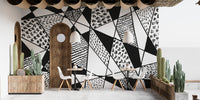 Patterned black and white mural with sharp geometric lines.
