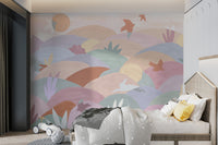 Soft-colored hills and plants with birds flying under a warm sun.