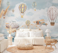 Colorful balloons drifting in the sky, with a vintage plane nearby.