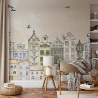 Soft watercolor houses mural with flying birds and cloudy pastel backgrounds.