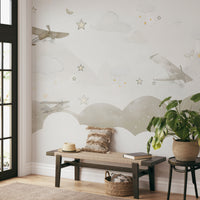 Classic airplanes soaring among watercolor clouds, scattered stars, and small butterflies.