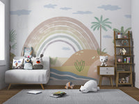 Serene rainbow over sandy hills, palm trees, and light blue clouds.