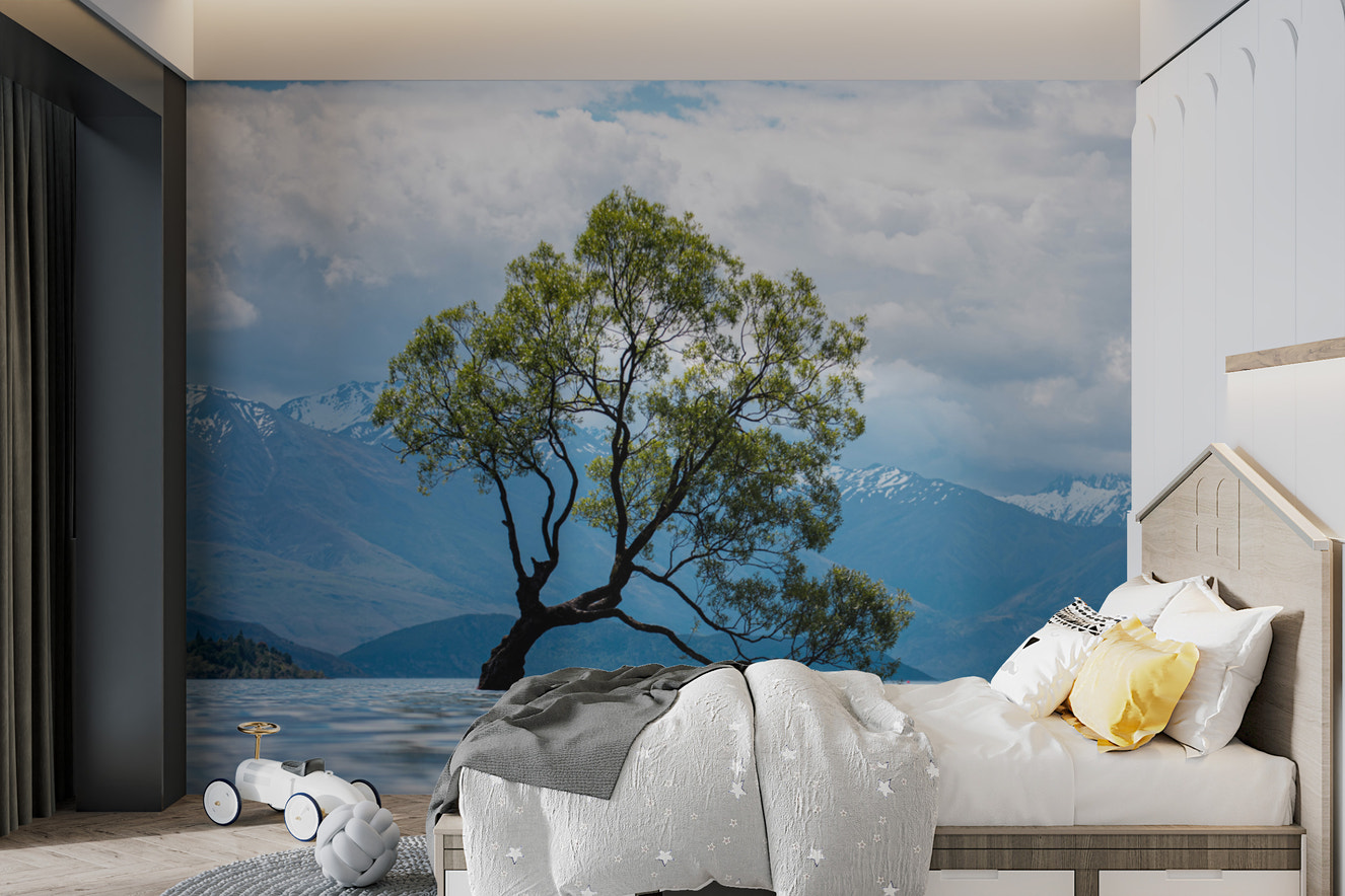 Lone tree in lake with mountain view wallpaper