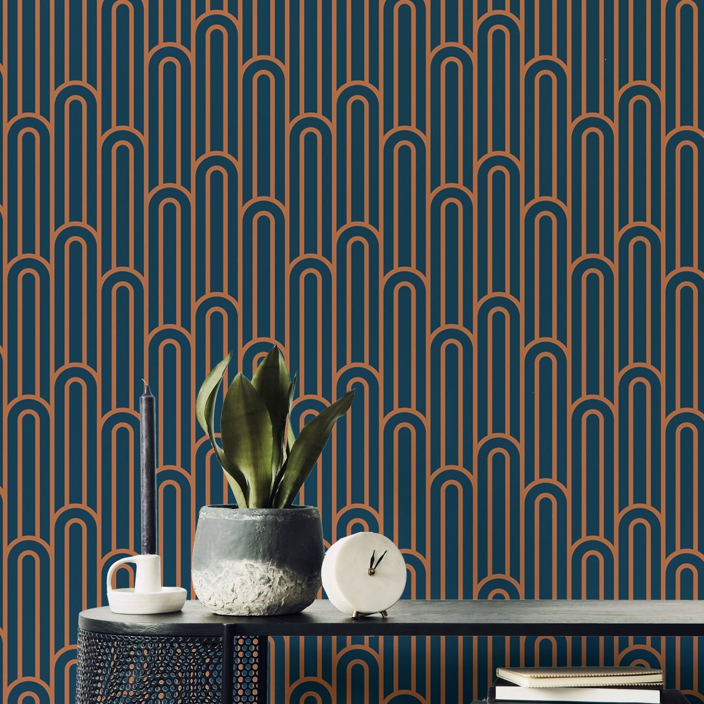 Art Deco arch pattern wallpaper in a workspace with a desk and plant.