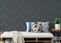 Linear Art Deco wallpaper behind a daybed with patterned blue cushions.
