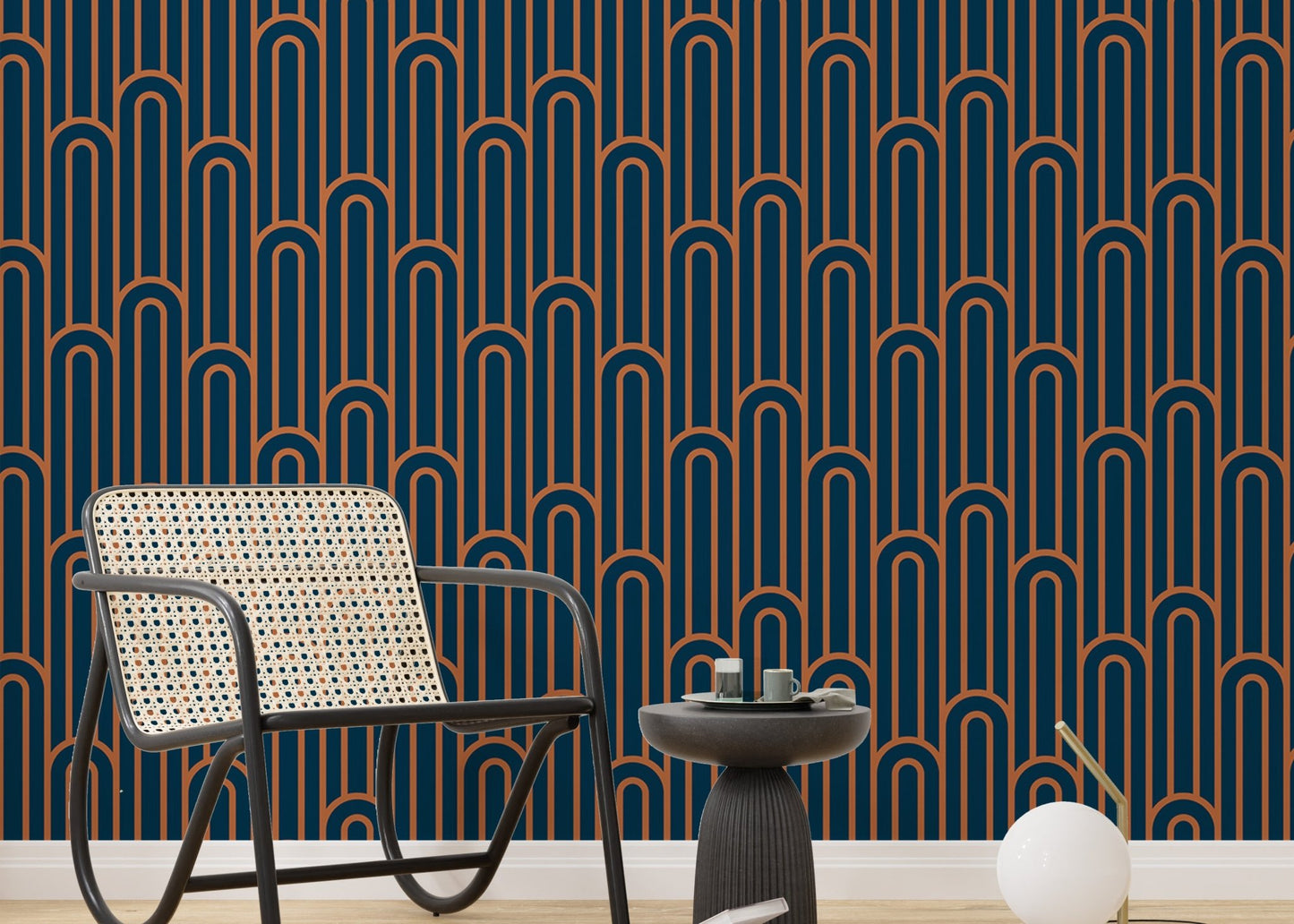 Dark navy and orange arch pattern wallpaper in a sitting with black furniture.