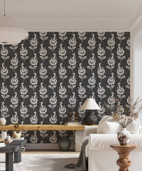 Vertical leaf pattern wallpaper in a living area with a wooden desk.
