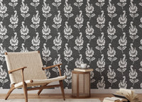 Autumn leaf wallpaper in a reading area with a wooden armchair.