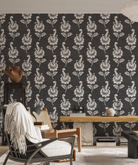 Black and white leaf wallpaper in a living area with a recliner chair.