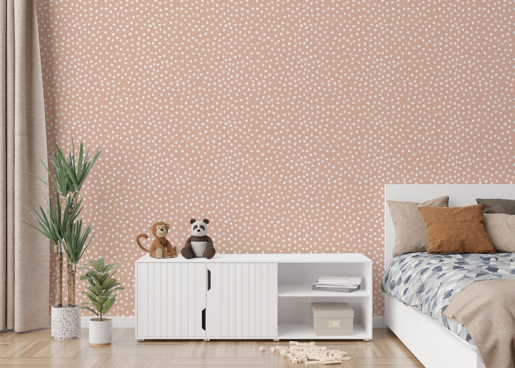 Soft beige brush dots wallpaper behind white cabinet in kids bedroom.
