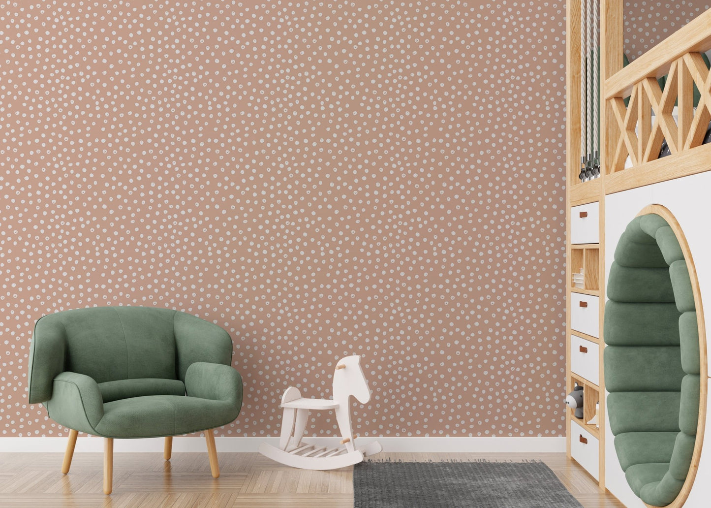Green armchair and rocking horse in front of beige wallpaper.



