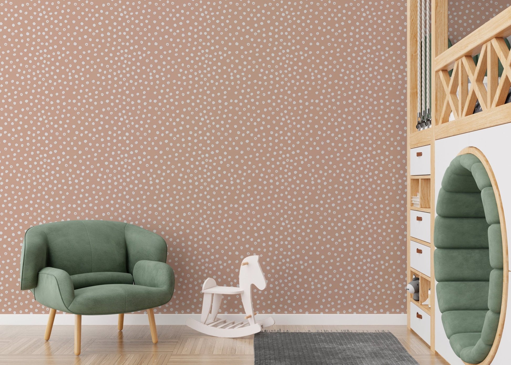 Green armchair and rocking horse in front of beige wallpaper.



