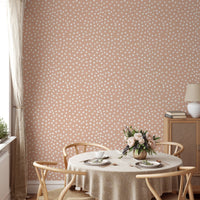 Beige and white brush polka dots abstract wallpaper in dining area.
