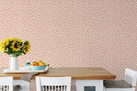 Kitchen dining table with sunflowers and white dot wallpaper.