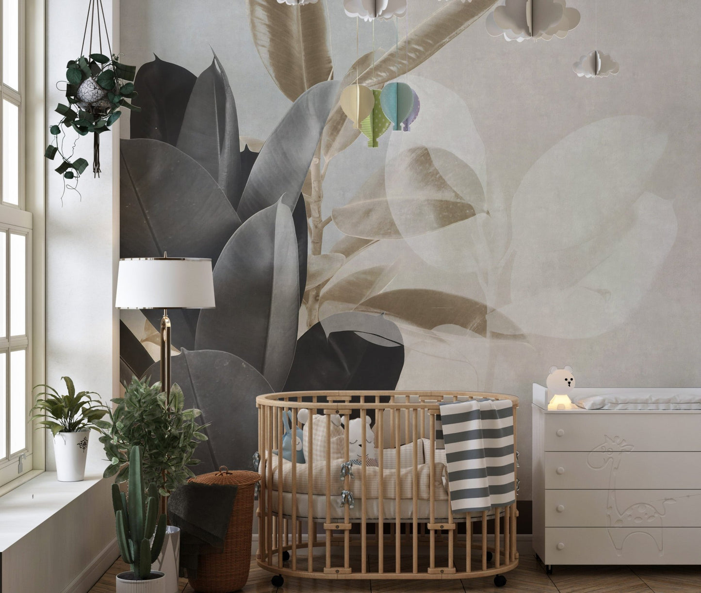 Nursery featuring a wooden crib against a botanical leaves wall mural with leaf silhouettes.