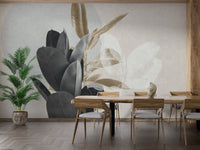 Dining area with wooden furniture and large-scale botanical leaves wall mural.
