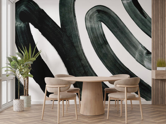 Abstract black ink mural creating a dramatic wall statement in dining area.
