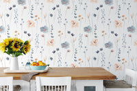 Blue and orange flower wallpaper in a dining room with a wooden table.