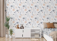 Abstract blue and beige flower leaves wallpaper in a bedroom with a white cabinet.