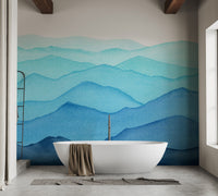 Layered blue watercolor wall mural in a modern bathroom