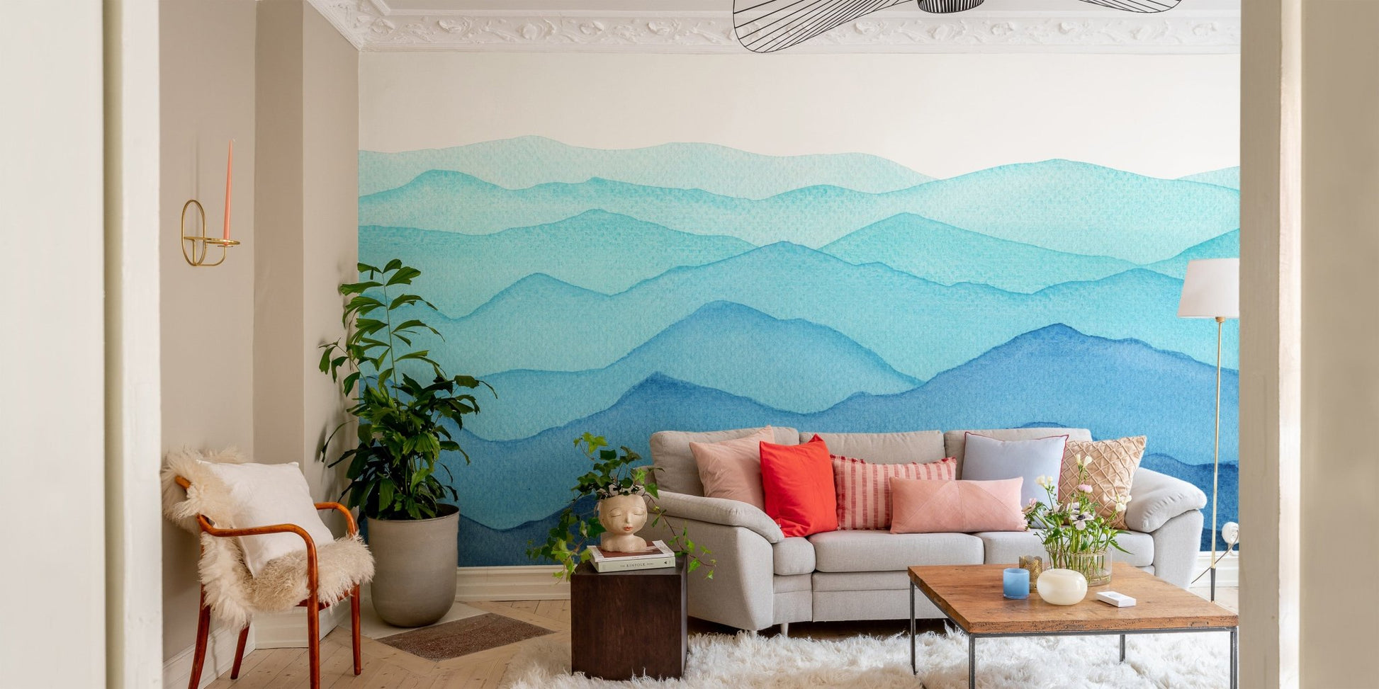 Soft blue watercolor wall mural in a small apartment living room