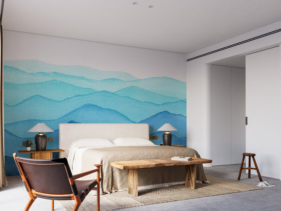 Blue watercolor wall mural for a serene bedroom with wooden furniture