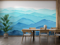 Blue watercolor mountain layers wall mural in a wooden dining room