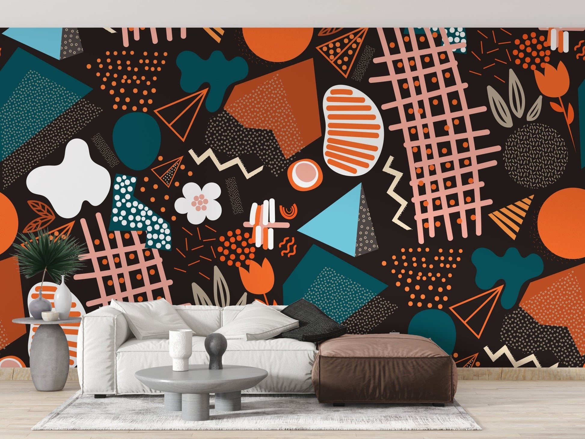 Modern living area with abstract art wall mural and brown leather ottoman.