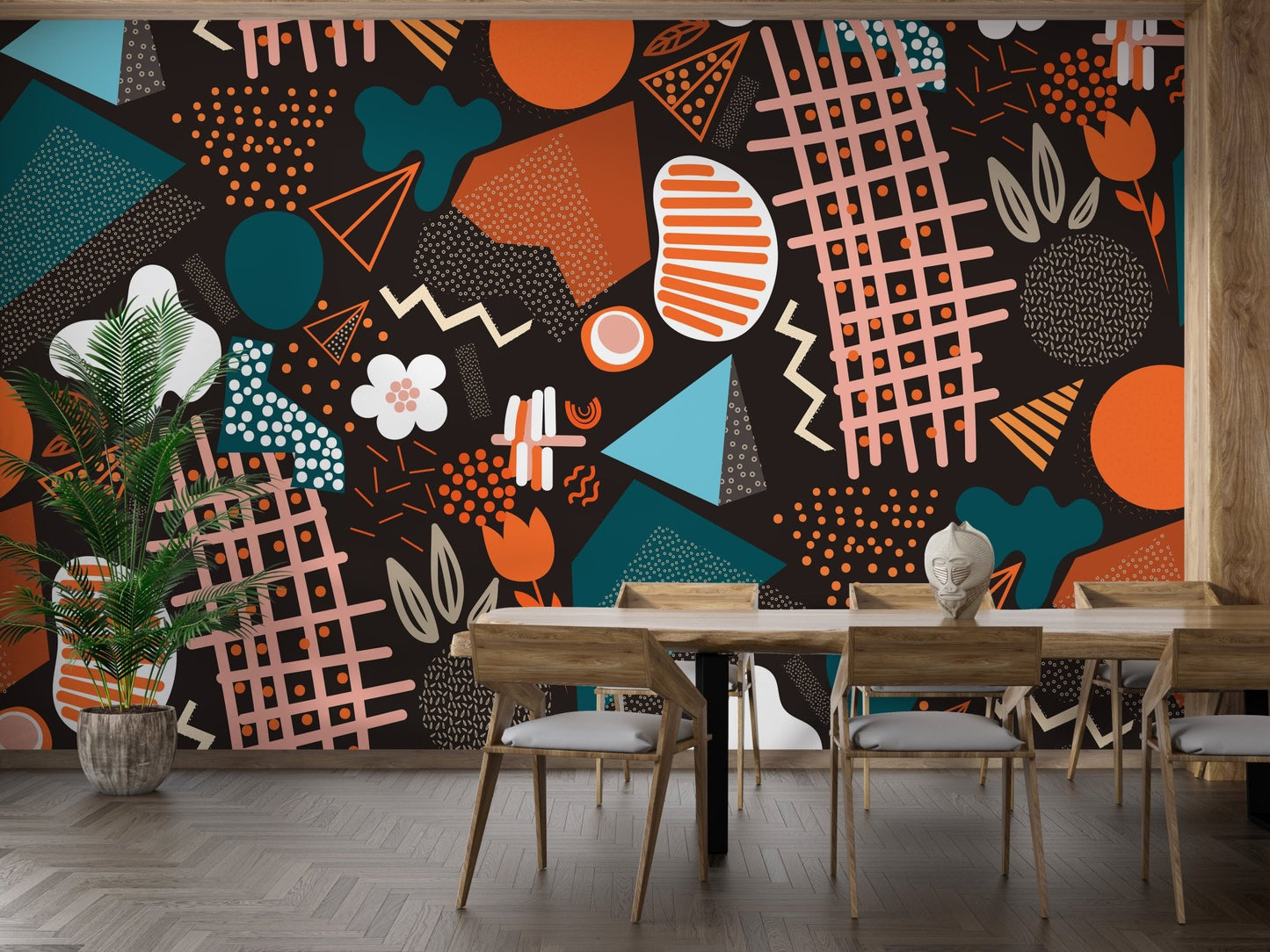 Dining room wall featuring multicolor geometric wall mural behind table.