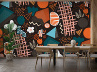Dining room wall featuring multicolor geometric wall mural behind table.