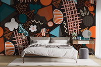Minimalist bedroom with dark abstract geometric wall mural and furniture.