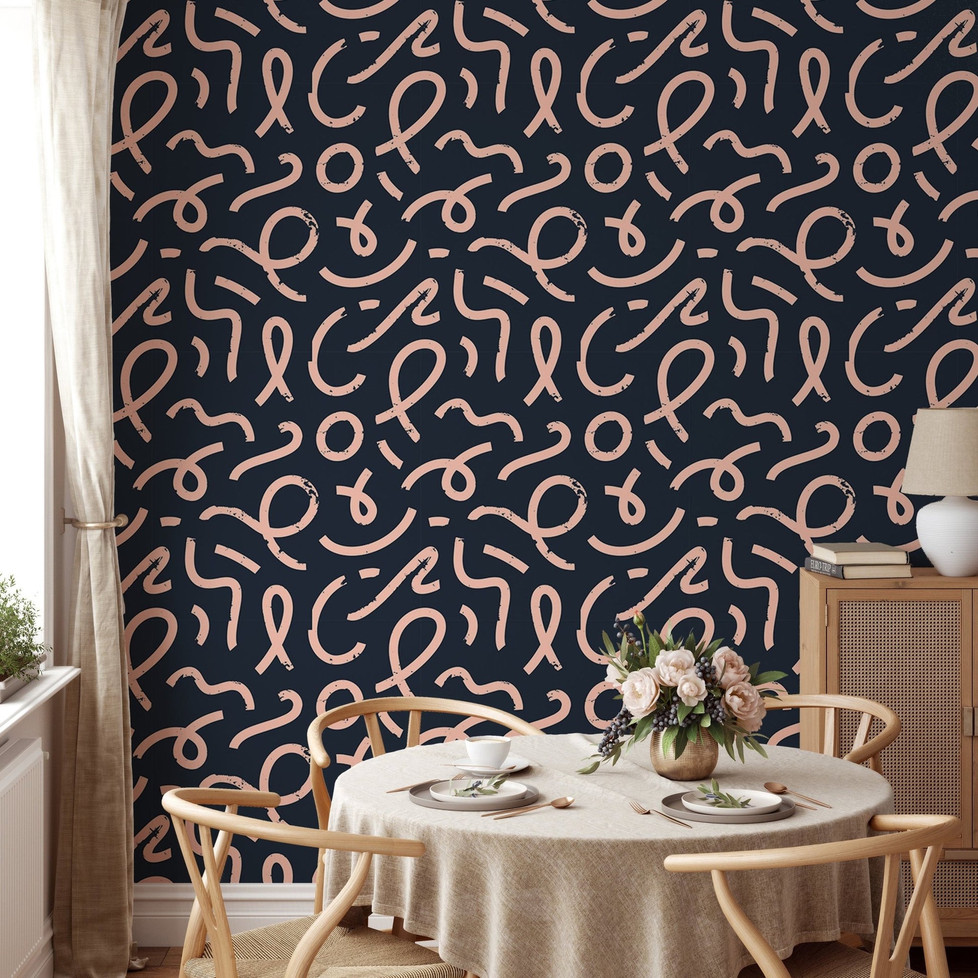 Minimalist line wallpaper in a dining room with a round wooden table.