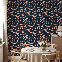 Minimalist line wallpaper in a dining room with a round wooden table.