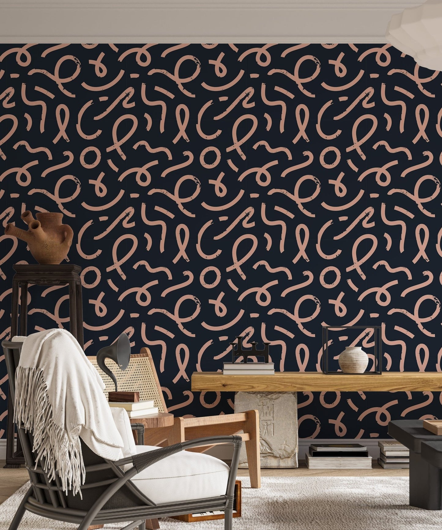 Navy blue geometric line wallpaper in a living room with a grey armchair and white rug.
