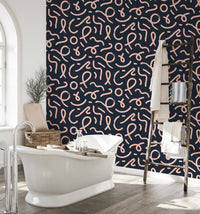 Dark navy wallpaper with pink line art in a modern bathroom with a white tub.