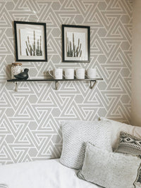 White line pattern wallpaper in a workspace with a floating shelf.
