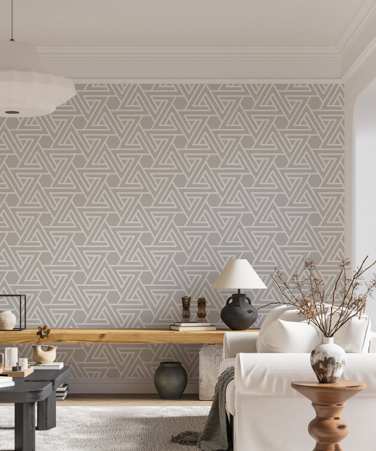 Grey geometric wallpaper in a bright living room with a white sofa.