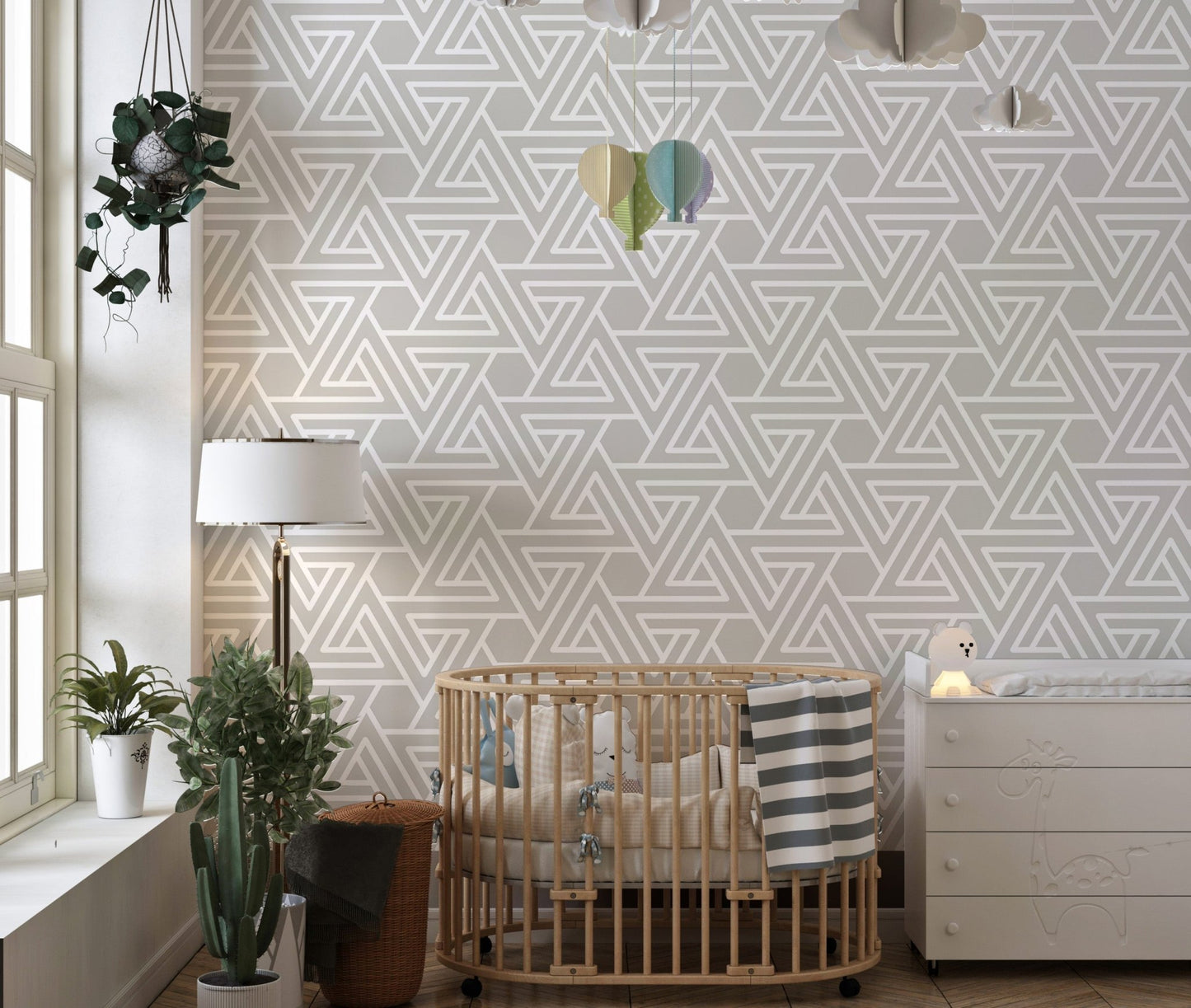 Simple line art wallpaper in a nursery with a wooden crib.