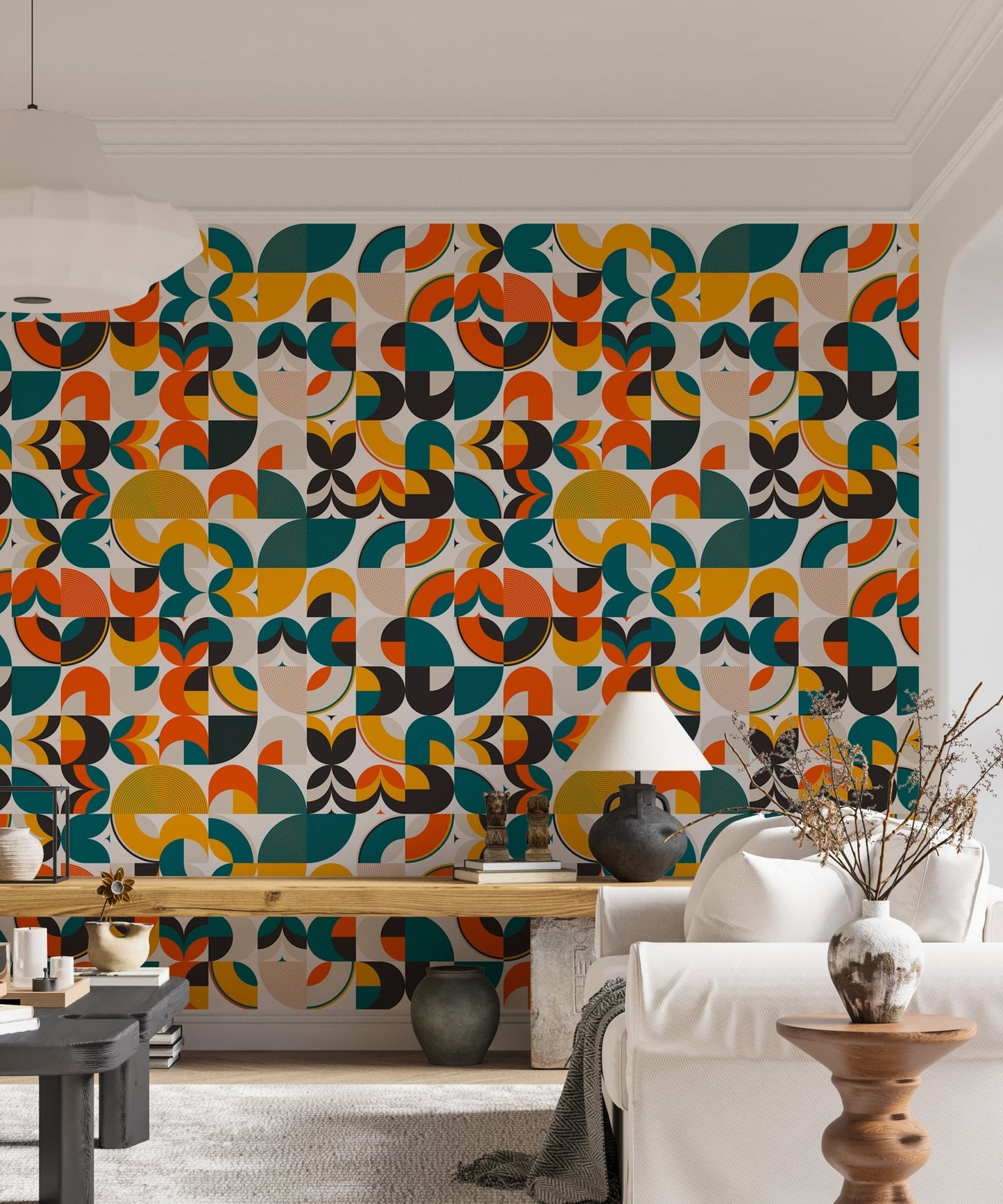 Multicolor geometric wallpaper behind a white sofa and wooden desk area.
