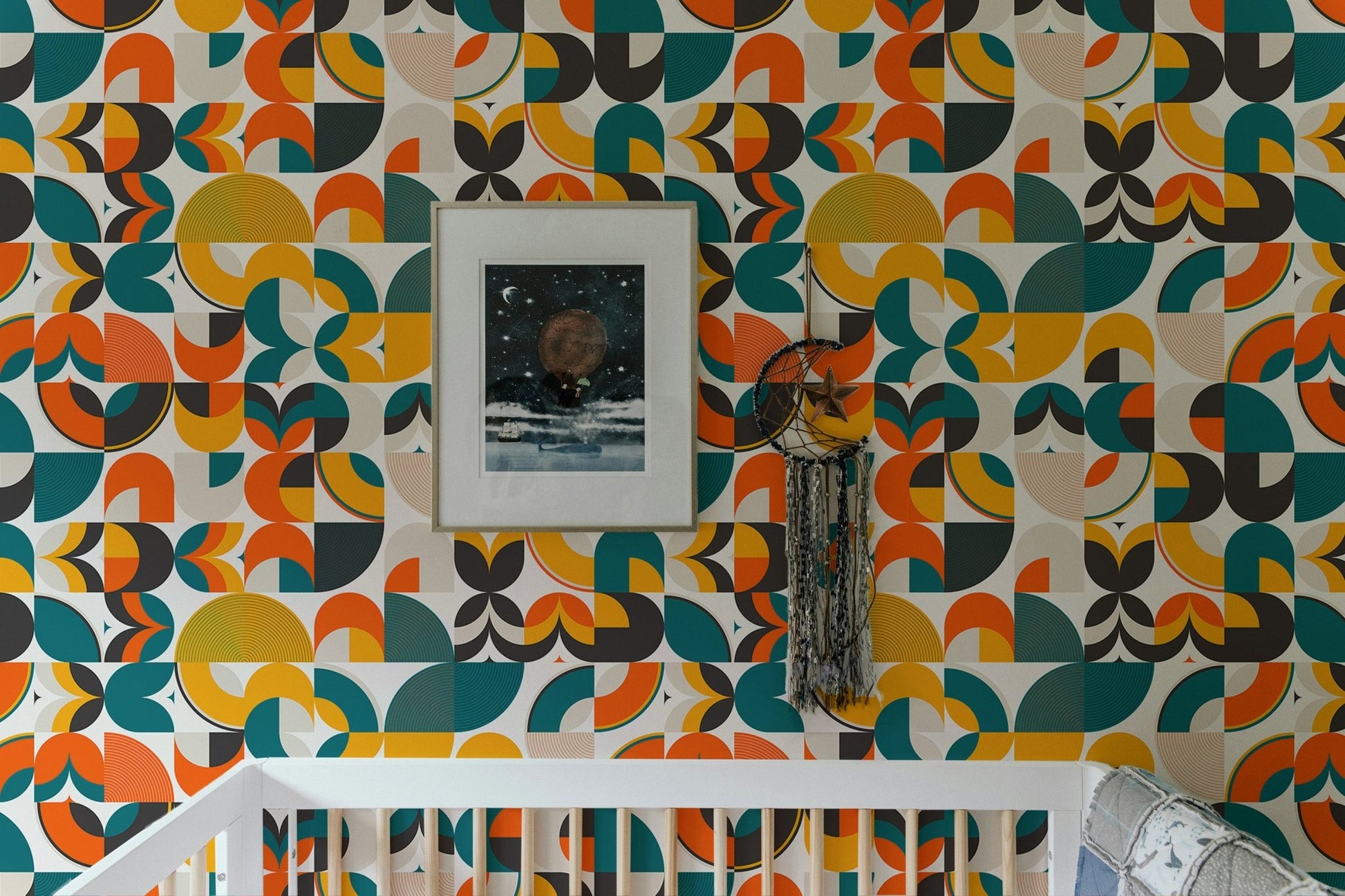 Scandi art wallpaper in a nursery above a white crib and framed picture.