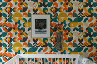 Scandi art wallpaper in a nursery above a white crib and framed picture.