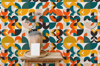 Mid-century vector pattern wallpaper featuring orange, green, and yellow shapes.