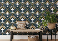 Navy and gold geometric abstract wallpaper in a room with a wooden bench and plants.