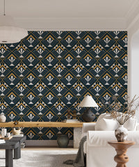 Patterned abstract wallpaper with gold accents in a living space with a white lamp.