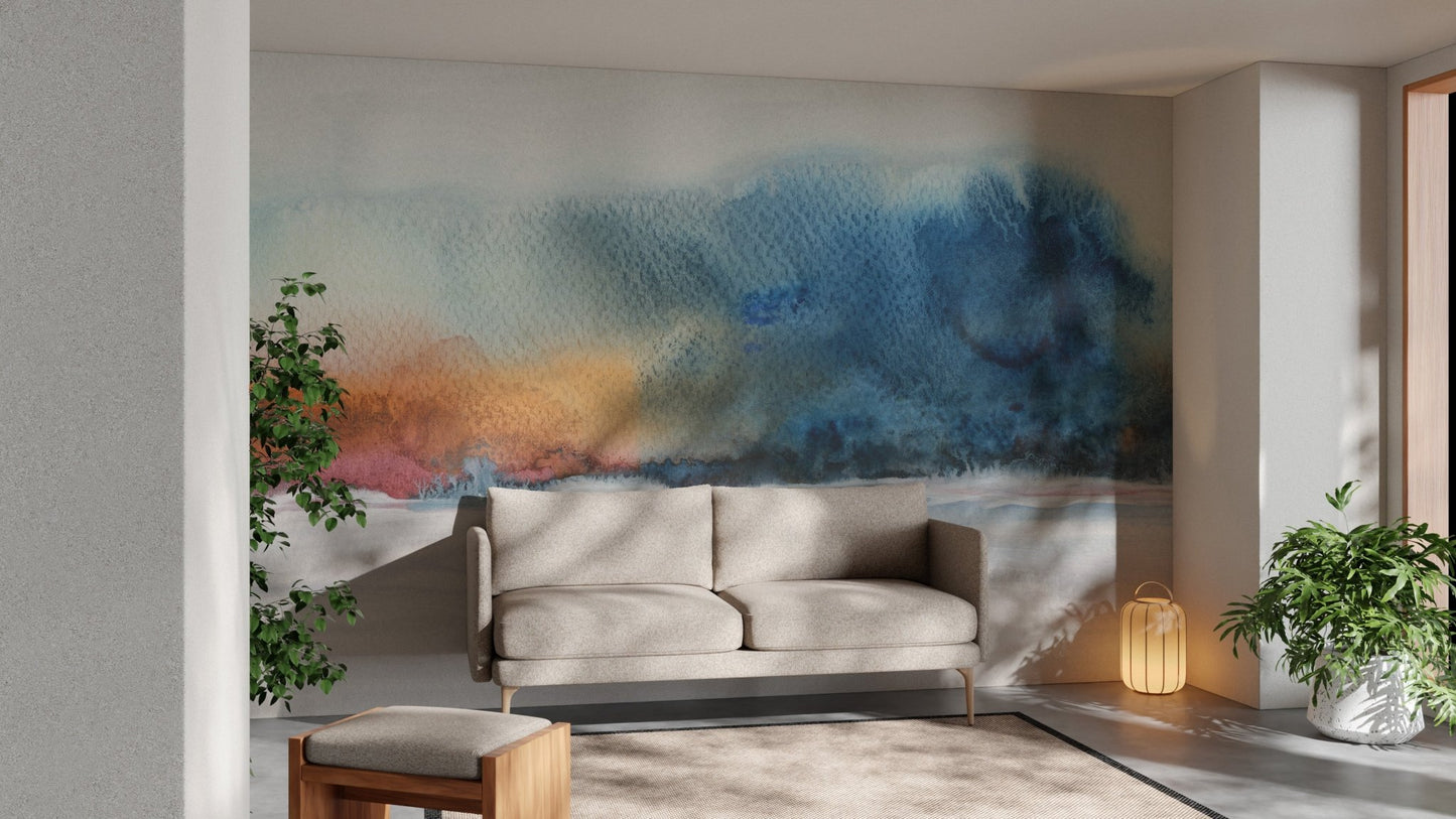 Blue and grey watercolor wall mural behind a light grey sofa.