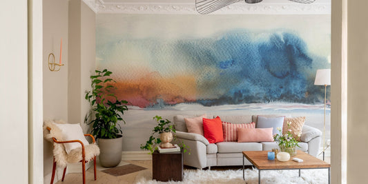 Abstract watercolor wall mural with blue and orange tones in a cozy living room.