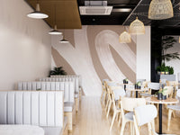 Abstract mural featuring soft, white wave patterns in cafe interior.
