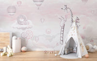 Kids room teepee tent set against a pink giraffe and cloud wall mural.