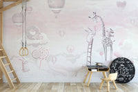 Gym rings in a playroom with light pink cartoon wall mural illustrations.
