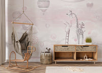 Playroom with pink sky wall mural, hanging chair and wooden storage unit.
